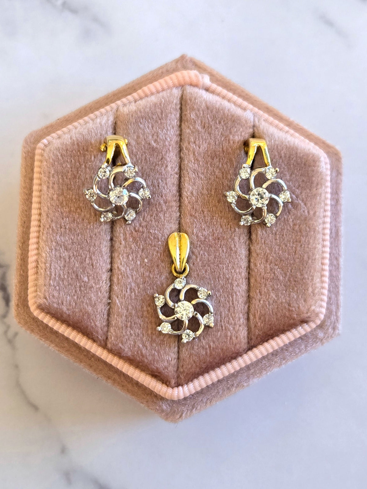 18K two-tone yellow and white gold pendant and matching earrings with floral openwork detailing and cubic zirconia stones.